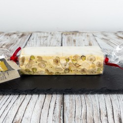 <h5>“Torrone” is a typical Christmas dessert, made from egg white, honey and sugar, almonds and with the addition of pistachios and hazelnuts.</h5>